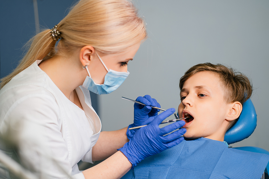 Dentist At Work And Her Little Young Cheerful Patient. Female Do